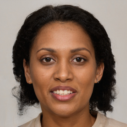 Joyful black young-adult female with medium  black hair and brown eyes