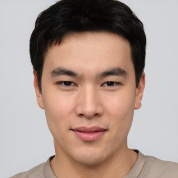 Joyful asian young-adult male with short  black hair and brown eyes