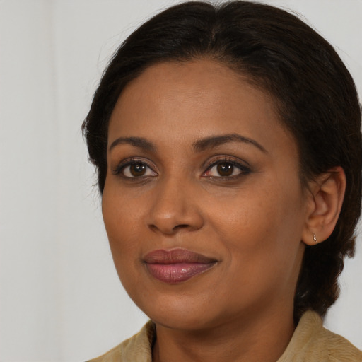 Joyful black young-adult female with medium  brown hair and brown eyes