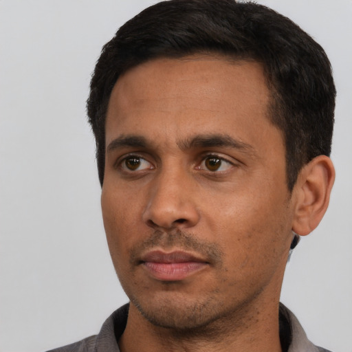 Neutral latino adult male with short  black hair and brown eyes