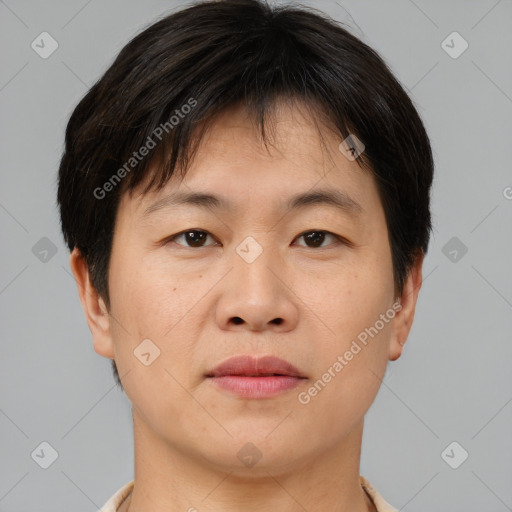 Joyful asian young-adult male with short  brown hair and brown eyes