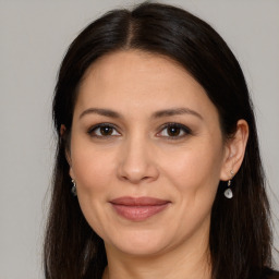 Joyful white adult female with long  brown hair and brown eyes