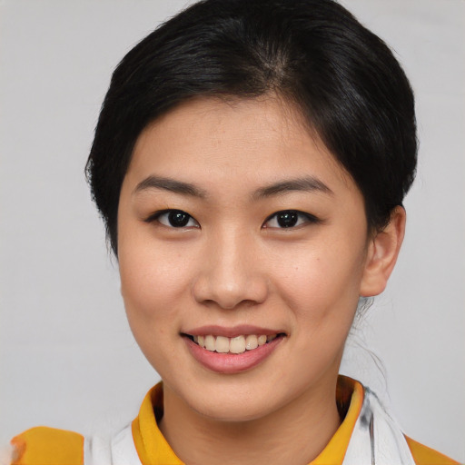 Joyful asian young-adult female with short  brown hair and brown eyes