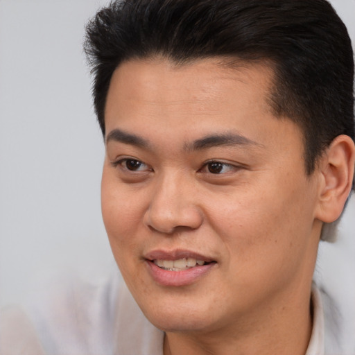 Joyful asian young-adult male with short  brown hair and brown eyes