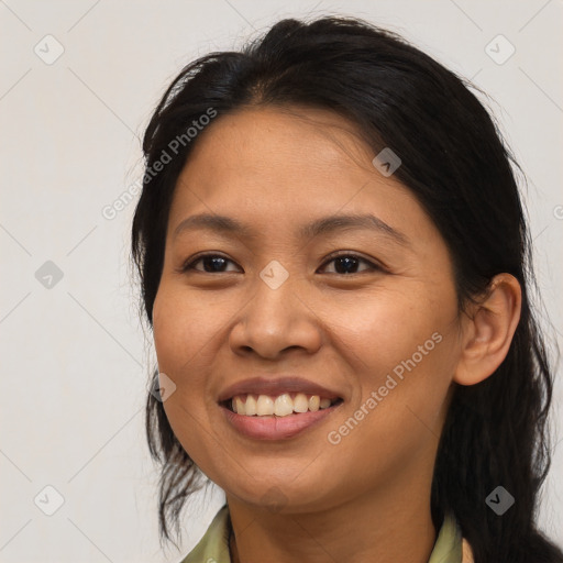 Joyful asian young-adult female with long  brown hair and brown eyes