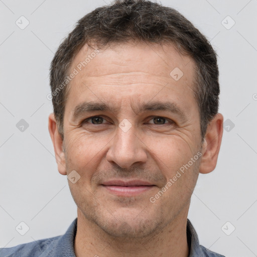 Joyful white adult male with short  brown hair and brown eyes