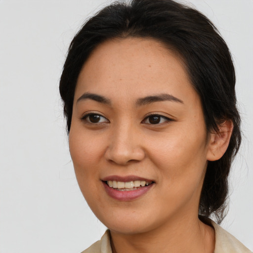 Joyful asian young-adult female with long  brown hair and brown eyes