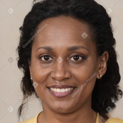 Joyful black adult female with medium  brown hair and brown eyes