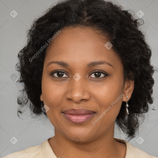 Joyful black adult female with medium  brown hair and brown eyes