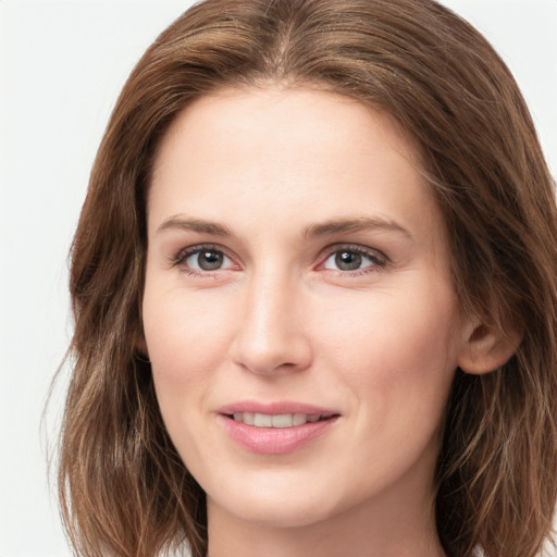 Joyful white young-adult female with long  brown hair and grey eyes