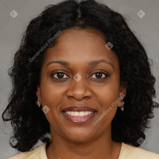 Joyful black young-adult female with long  brown hair and brown eyes