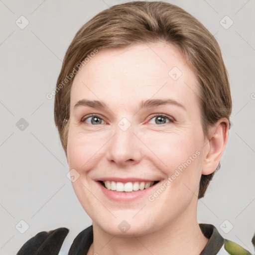 Joyful white young-adult female with medium  brown hair and grey eyes