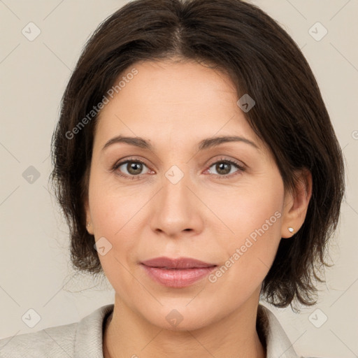 Joyful white adult female with medium  brown hair and brown eyes