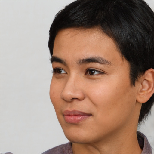 Joyful asian young-adult male with short  black hair and brown eyes