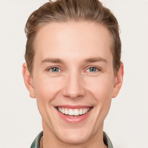 Joyful white young-adult male with short  brown hair and grey eyes