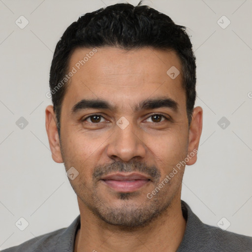 Joyful latino young-adult male with short  black hair and brown eyes
