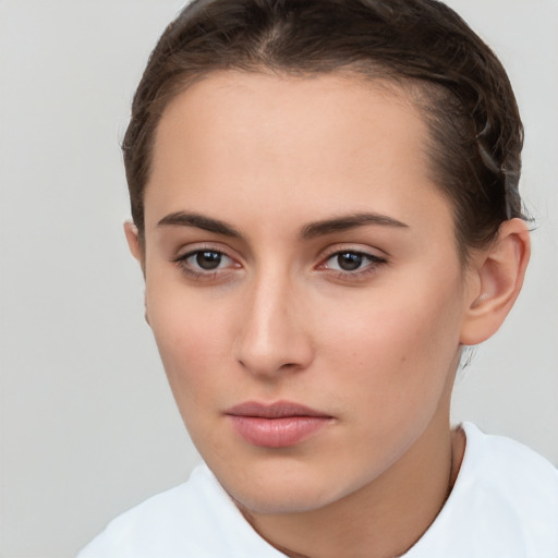 Neutral white young-adult female with short  brown hair and brown eyes