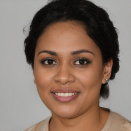 Joyful black young-adult female with medium  brown hair and brown eyes