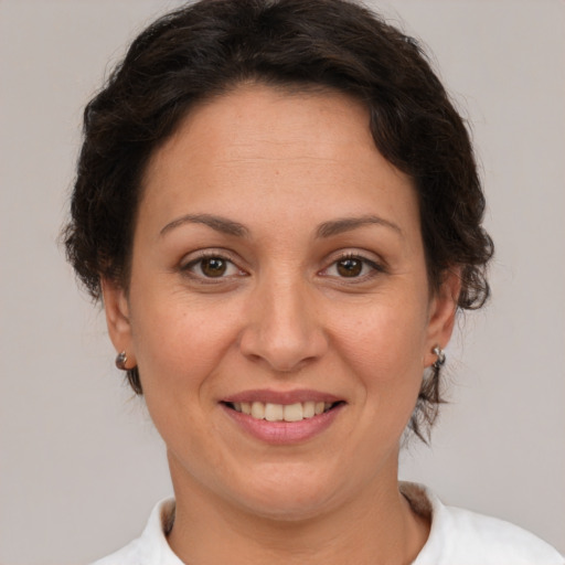 Joyful white adult female with short  brown hair and brown eyes