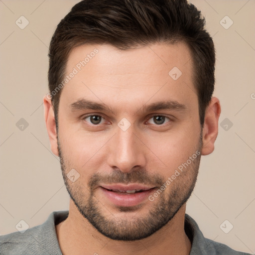 Joyful white young-adult male with short  brown hair and brown eyes