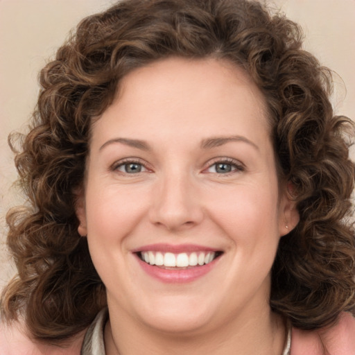 Joyful white young-adult female with medium  brown hair and green eyes