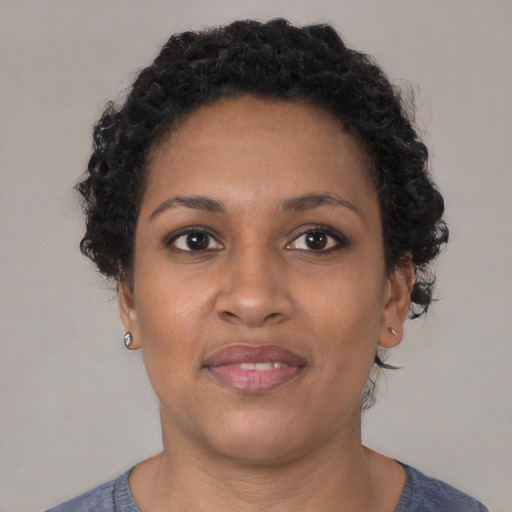 Joyful black young-adult female with short  brown hair and brown eyes