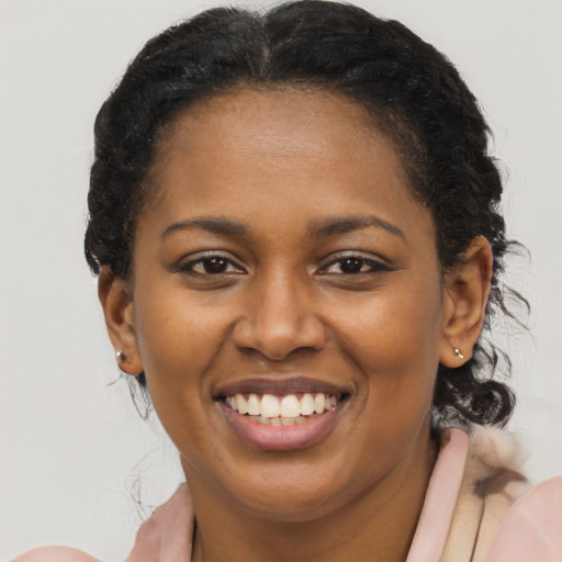 Joyful black young-adult female with medium  brown hair and brown eyes