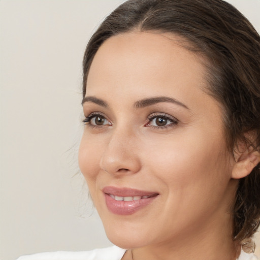 Joyful white young-adult female with medium  brown hair and brown eyes