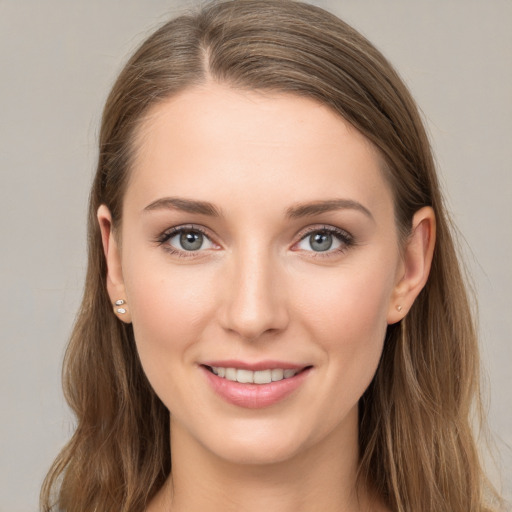 Joyful white young-adult female with long  brown hair and grey eyes