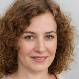 Joyful white young-adult female with medium  brown hair and green eyes