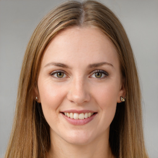 Joyful white young-adult female with long  brown hair and green eyes