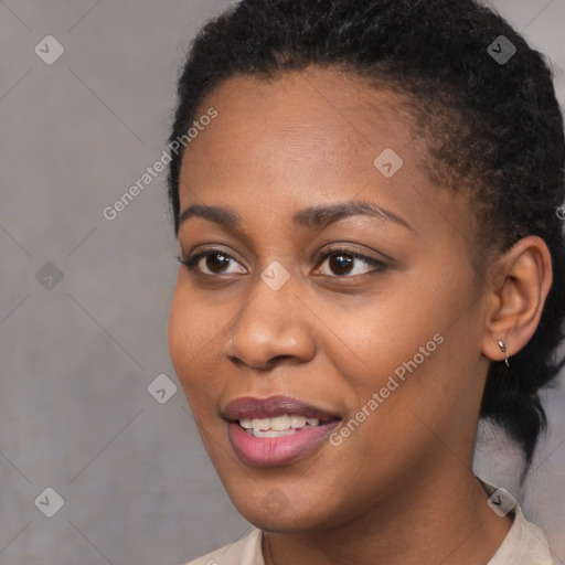 Joyful black young-adult female with short  black hair and brown eyes