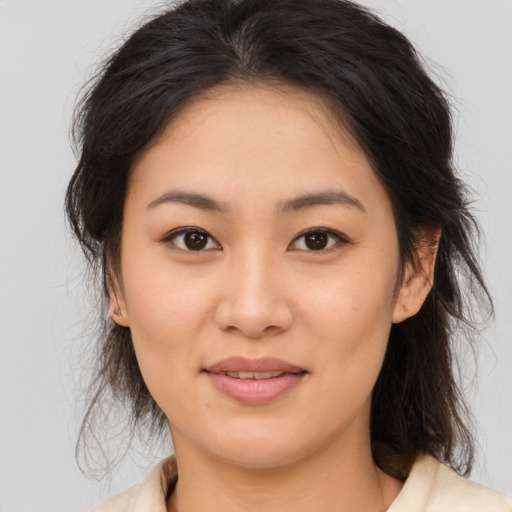 Joyful asian young-adult female with medium  brown hair and brown eyes