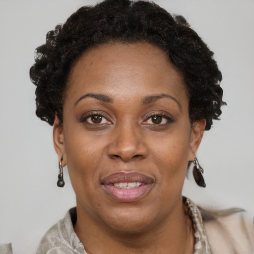 Joyful black adult female with short  brown hair and brown eyes