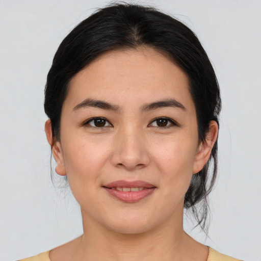 Joyful white young-adult female with medium  black hair and brown eyes