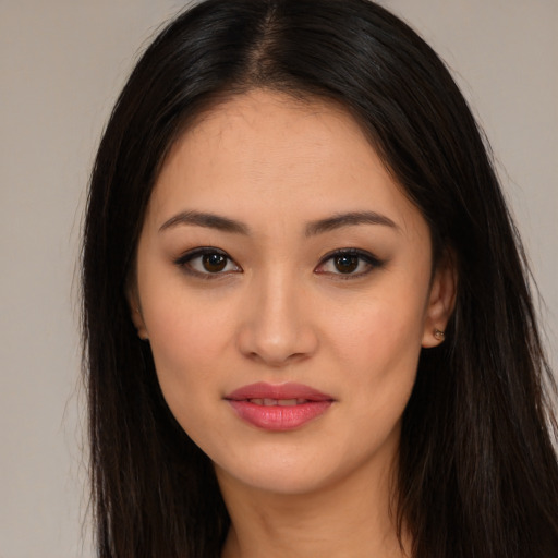 Joyful asian young-adult female with long  brown hair and brown eyes