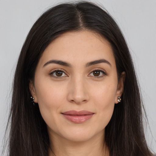 Joyful white young-adult female with long  brown hair and brown eyes