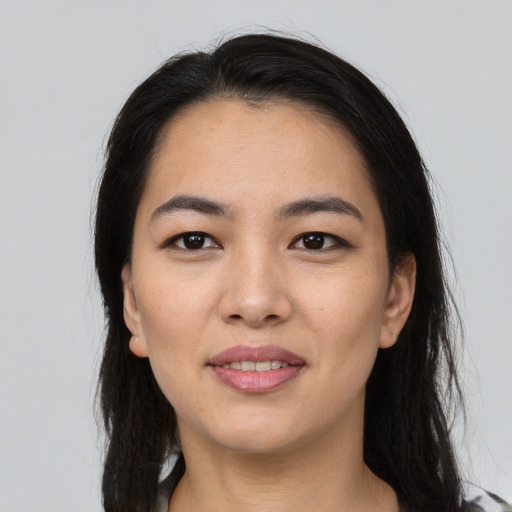 Joyful asian young-adult female with long  black hair and brown eyes