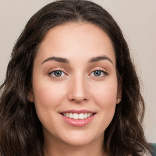 Joyful white young-adult female with long  brown hair and green eyes