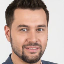 Joyful white young-adult male with short  brown hair and brown eyes