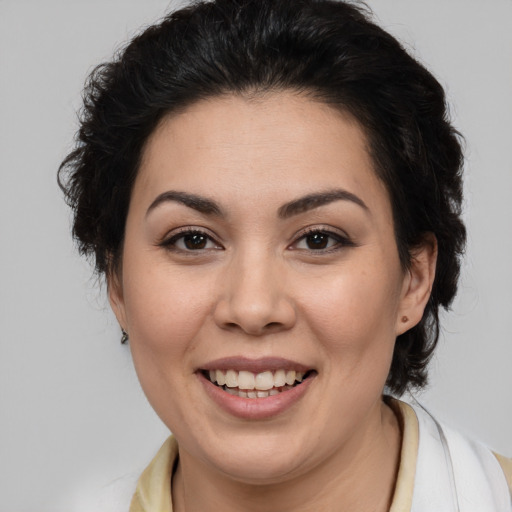 Joyful latino young-adult female with medium  brown hair and brown eyes