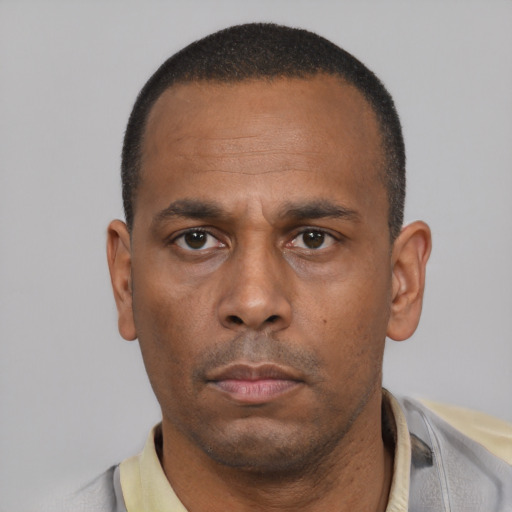 Neutral latino adult male with short  black hair and brown eyes