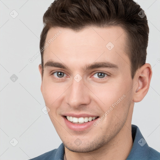 Joyful white young-adult male with short  brown hair and brown eyes