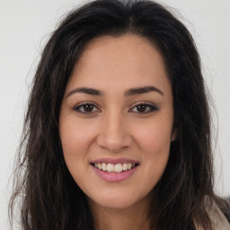 Joyful latino young-adult female with long  brown hair and brown eyes