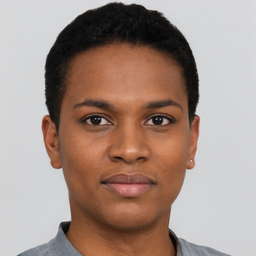 Joyful black young-adult female with short  black hair and brown eyes