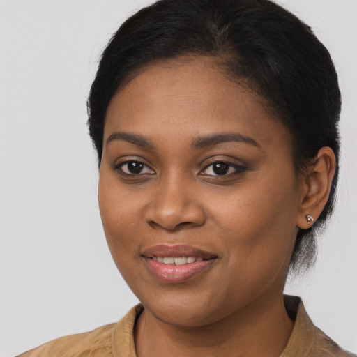 Joyful black young-adult female with long  brown hair and brown eyes