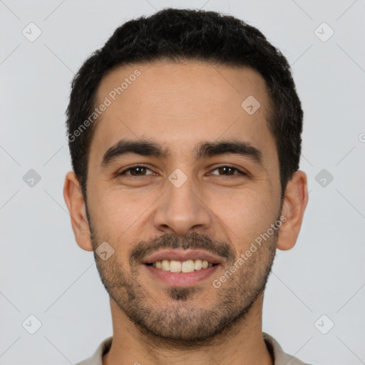 Joyful white young-adult male with short  black hair and brown eyes