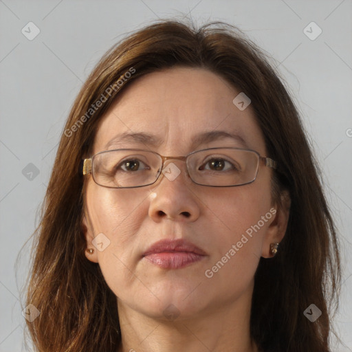 Joyful white adult female with long  brown hair and brown eyes