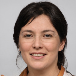 Joyful white adult female with medium  brown hair and brown eyes