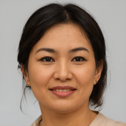 Joyful asian young-adult female with medium  brown hair and brown eyes